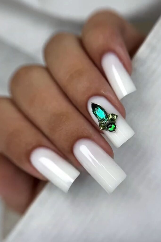 White chrome coffin nails with metallic butterfly accent.